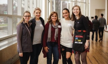 Four smiling guests with a renegade tour guide at the museum.